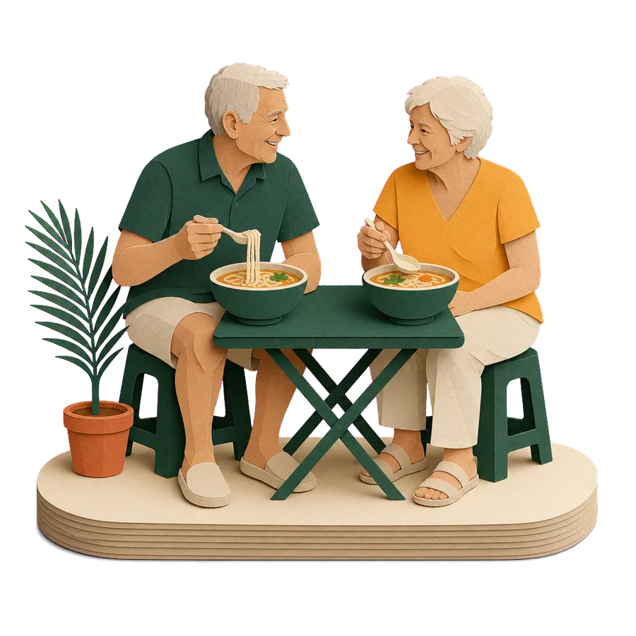 A couple around 70 eating noodle soup at a street table, an example of the real costs of retiring overseas